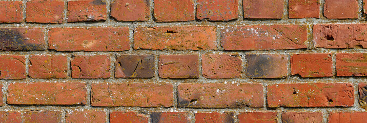 Wide weathered red brick wall background