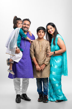 Happy Indian Family Standing On White Background.