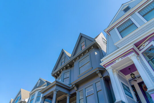 View of victorian houses from below against the sky in San Francisco, CA