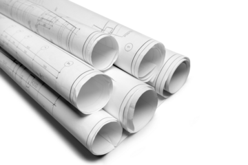 Architectural blueprints and blueprint rolls on white background.
