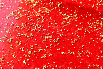 Fallen blossoms one ivy on the red hood of a car