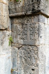 Armenia, Tatev, September 2022. Fragment of a temple wall with religious symbols.