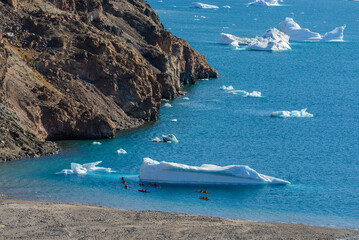 Kayaking in Arctic sea near iceberg