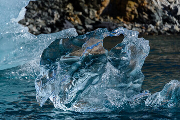 Piece of ice in clean water. Iceberg.