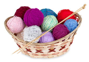 Balls of yarn in a basket with knitting needles