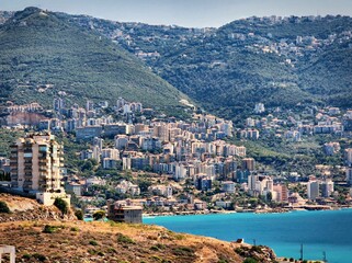 Scenic coast on the hillside with buildings against the azure sea in Lebanon