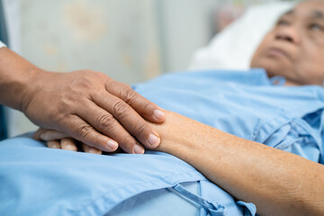 Doctor holding touching hands Asian senior or elderly old lady woman patient with love, care, helping, encourage and empathy at nursing hospital ward, healthy strong medical concept