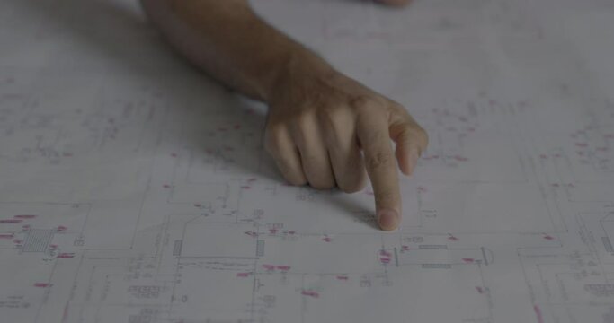 Finger pointing a spot on the blueprint. Engineer at work showing the path on the project map. 4k