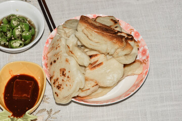 Lunch of traditional Chinese food sausage, rolls, chili, pomegranate, soy bean curd