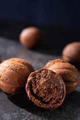 Tasty chocolate balls on a stone dark table.