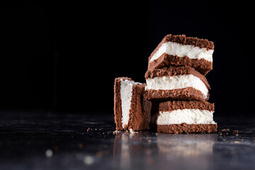 Tasty chocolate biscuit cake on a stone dark background