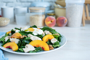 top view plate with tasty peach and spinach salad on wooden table