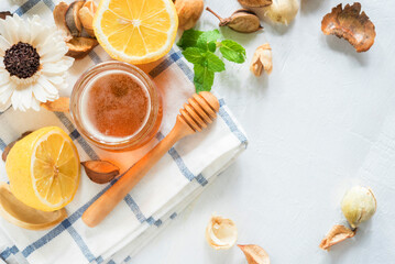 Honey with fresh lemon on wooden table background,  honey dipper