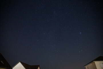 Starry sky over a housing settlement with meteorites (Perseids in August)