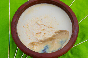 Homemade Mishti Doi or sweet dahi or curd made with milk and sugar or jaggery in earthen pot. It is popular Indian dessert of West Bengal, Assam and Odisha.