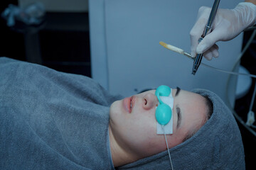 woman getting facial massage with oxy air spray .oxygen therapy in spa salon.close up cheek face of...
