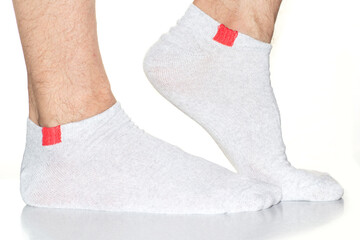 white men's socks with a red insert on the feet, legs in socks on a white background