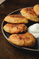 Cottage cheese pancakes,curd fritters with sour cream in a dish. Gourmet Breakfast
