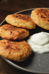 Cottage cheese pancakes,curd fritters with sour cream in a dish. Gourmet Breakfast
