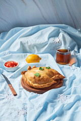 Traditional Argentinian baked empanadas on a wooden plate