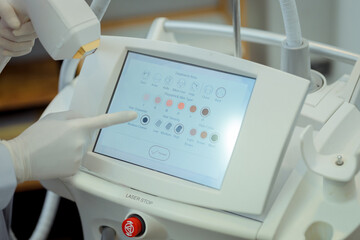 Doctor's hand with device HydraFacial facial skin care machine in spa clinic for anti-aging or acne...
