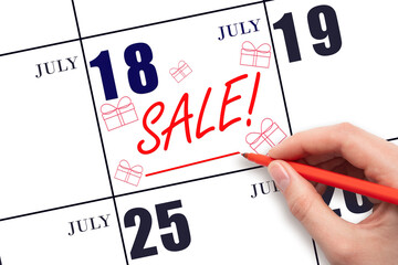 Hand writing text SALE and drawing gift boxes on calendar date July 18. Shopping Reminder