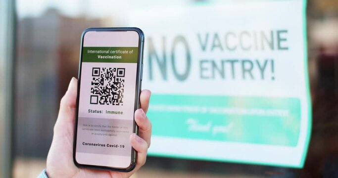 Smartphone with digital health passport app in mobile phone with covid-19 certificate. No vaccine no entry service. Digital green certificate of immunization with qr code