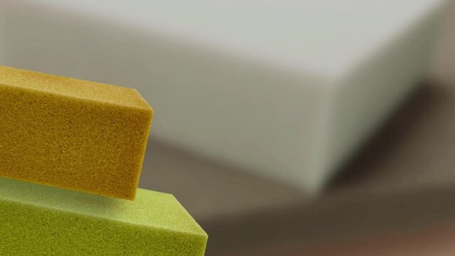 square pieces of soft colorful thick thick sponge foam on blurred background. 