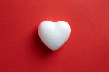 Obraz premium Love shape make from Styrofoam board isolated on red background