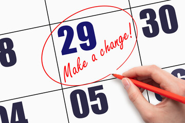 29th day of the month. Hand writing text MAKE A CHANGE and circling the calendar date. Business...