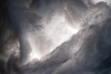 Fototapeta na wymiar Abstract image made using colored light and cotton snow, artificial snow. Dramatic concept of clouds in the sky, storm at sea, light and dark, atmospheric states. Background or wallpaper.