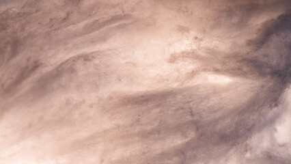 Abstract image made using colored light and cotton snow, artificial snow. Dramatic concept of clouds in the sky, storm at sea, light and dark, atmospheric states. Background or wallpaper.