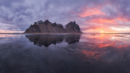 Snowy mountains near frozen lake