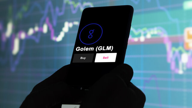 September 13th 2022, London UK. An investor's analyzing the Golem (GLM) coin on screen. A phone shows the crypto's prices to invest