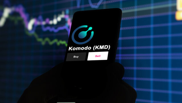 September 13th 2022, London UK. An investor's analyzing the Komodo (KMD) coin on screen. A phone shows the crypto's prices to invest