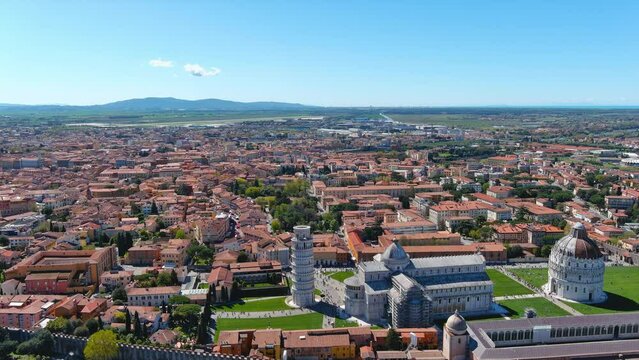Pisa City aerial view with Leaning Tower of Pisa white-marble cylinder is the bell tower of the Romanesque, striped-marble cathedral that rises next to it in the Piazza dei Miracoli in Tuscany, Italy