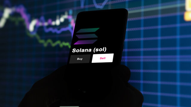 An investor's analyzing the solana coin on screen. A phone shows the $SOL prices to invest