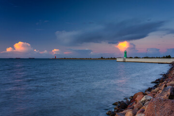 Green lighthouse on the western breakwater in Nowy Port at sunset, Gdansk.