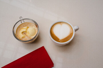 Two different coffees on a cafe wooden table 