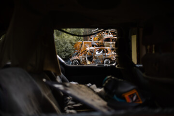 A pile of rusty burnt cars in Irpen in April 2022, shot at by Russian troops. A cemetery of wrecked...