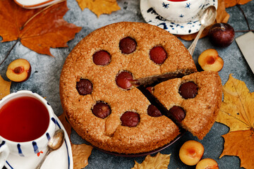Plum pie. Delicious pie on a concrete table. Autumn design
