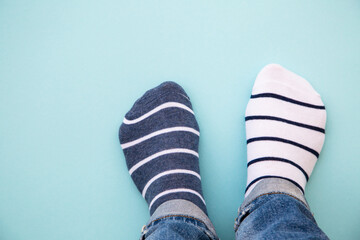 Odd socks day concept. Mismatch socks at blue.
