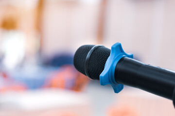 Fototapeta premium Public Microphone for speaking blure backgrounds, Close-up microphone on stand for speaker speech in seminar room with Event light convention hall for Business meeting and Education