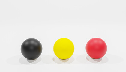 3d-rendering of three balls in the colours black, red and yellow as the colours of the belgium national flag