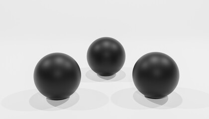 Abstract 3d-rendering of three black balls in front of a white background 