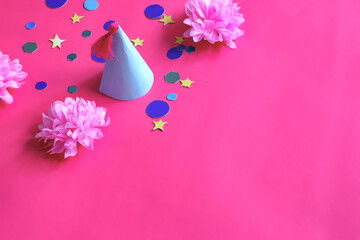 pink background with birthday hat, pink flowers and colorful geometric shapes