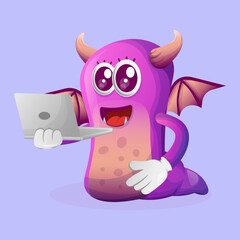 Cute purple monster working using a laptop