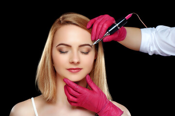 Eyebrows permanent makeup procedure against black background