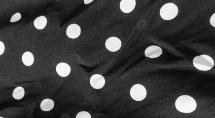 Black crumpled background with white circles. Background without people.