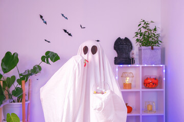 A ghost eats Halloween sweets. A ghost eats worms, candy, sweets or muck, trick or treat. Happy Halloween. Neon light.